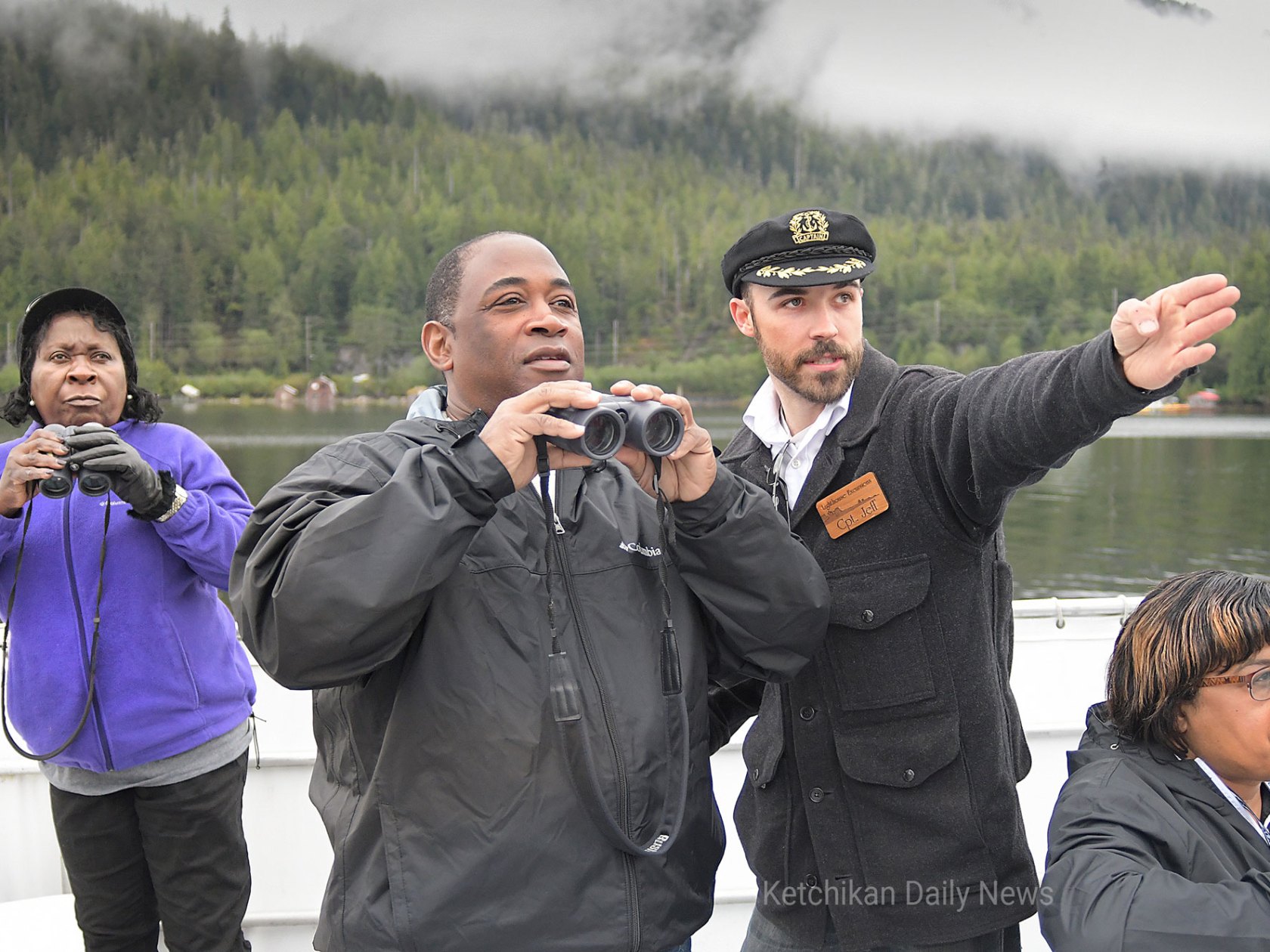 Capt. Jeff Karlson helps Dr. Emmanuel Ashong, of Camden, NJ, locate eagles along the coastline on Thursday during a guided boat tour with Lighthouse Excursions. Staff photo by Dustin Safranek