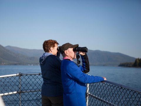 a person standing next to a body of water